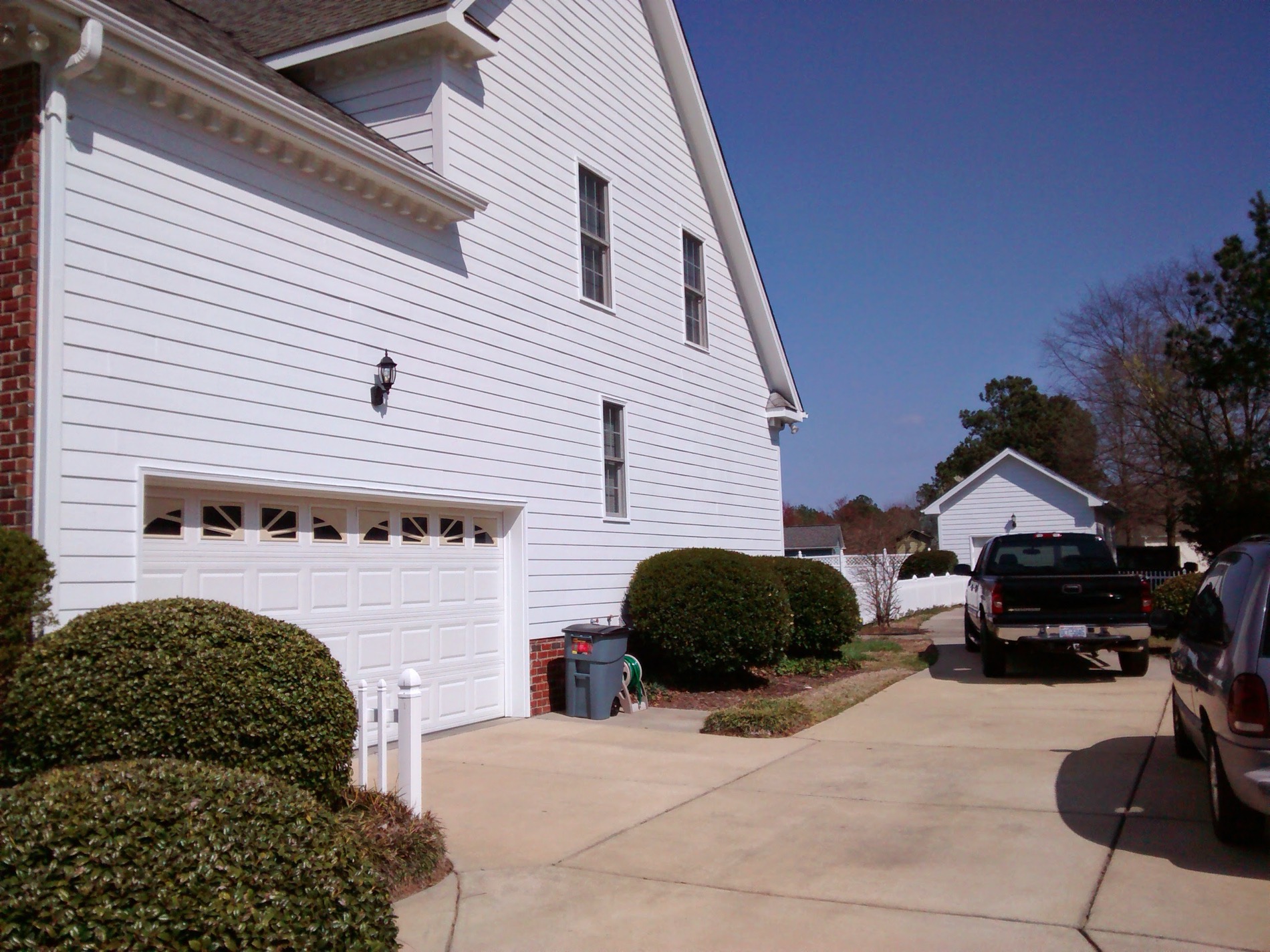 Clean lap siding and garage, washed and repainted end to end.